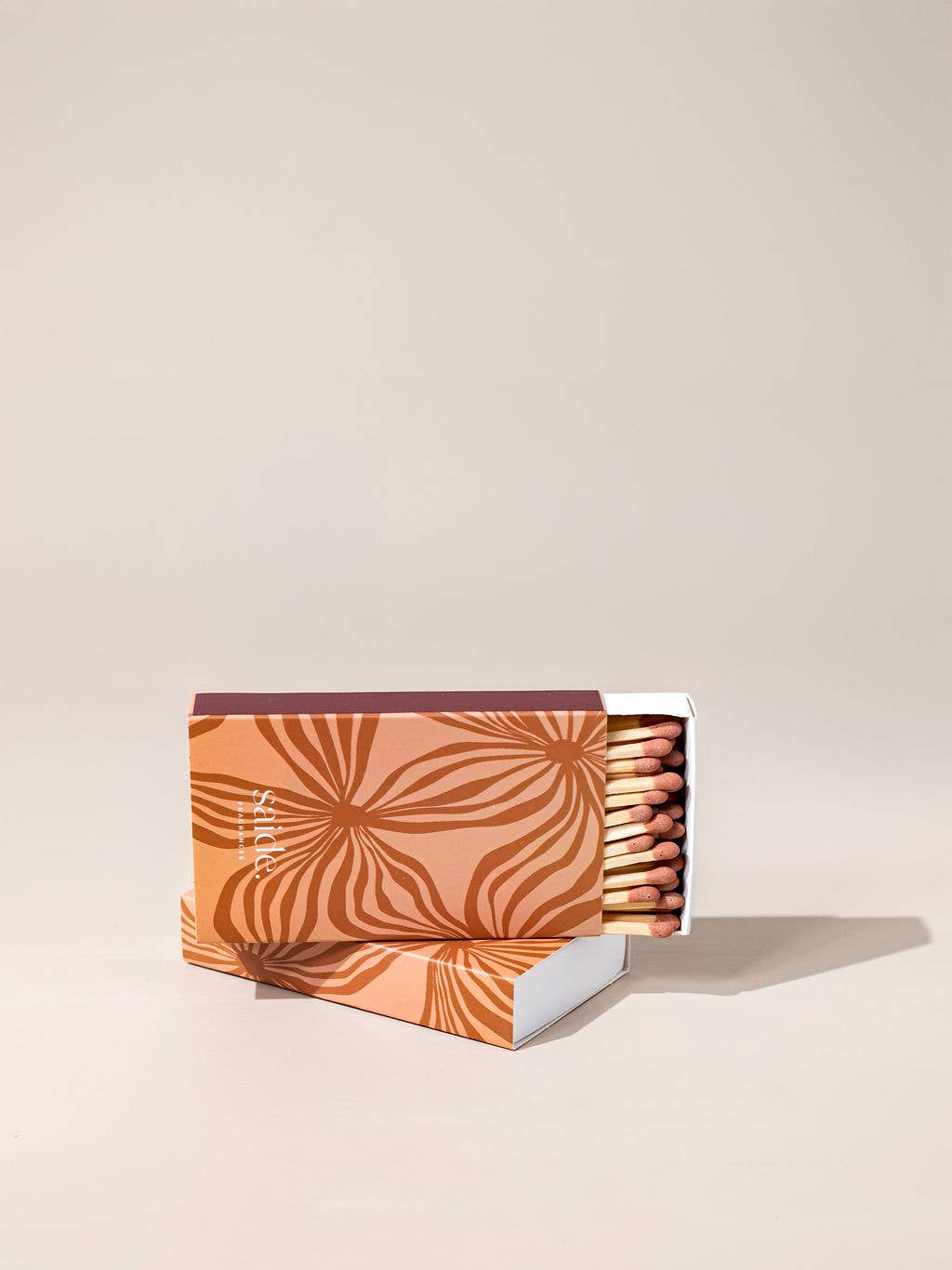 Matches with decorative packaging on a beige background