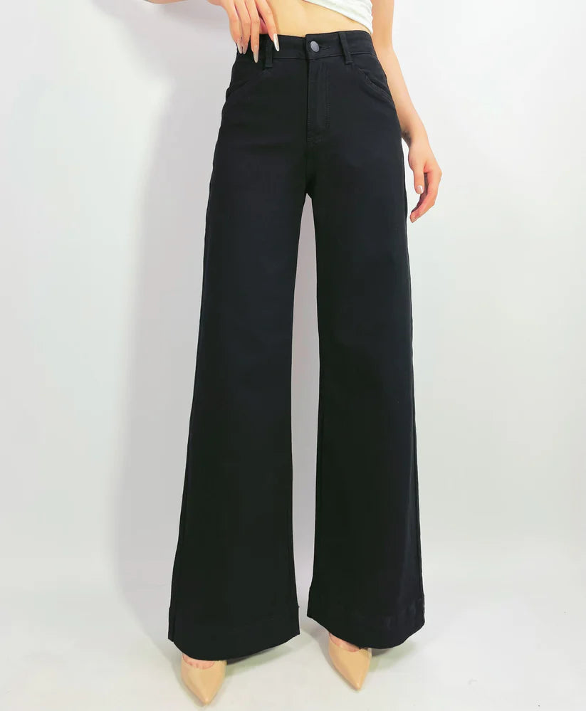 Black wide-leg pants worn by a person on a white background