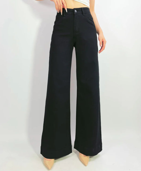 Black wide-leg pants worn by a person on a white background