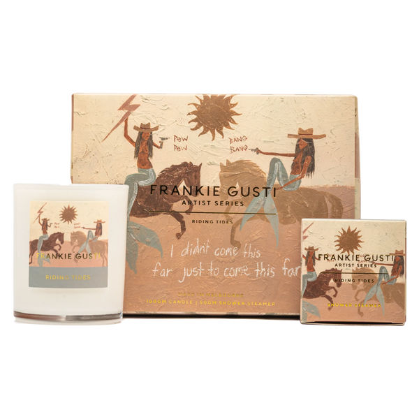 candle and shower steamer set , artwork on box and items is by artist Tahnee Kelland and is beige with a sun and cowboy mermaids on horses shooting guns, text says I didn't come this far just to come this far