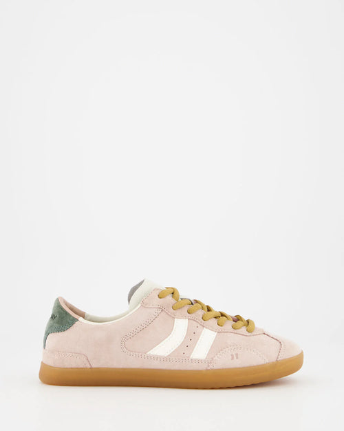 Pink sneaker with yellow laces on a white background