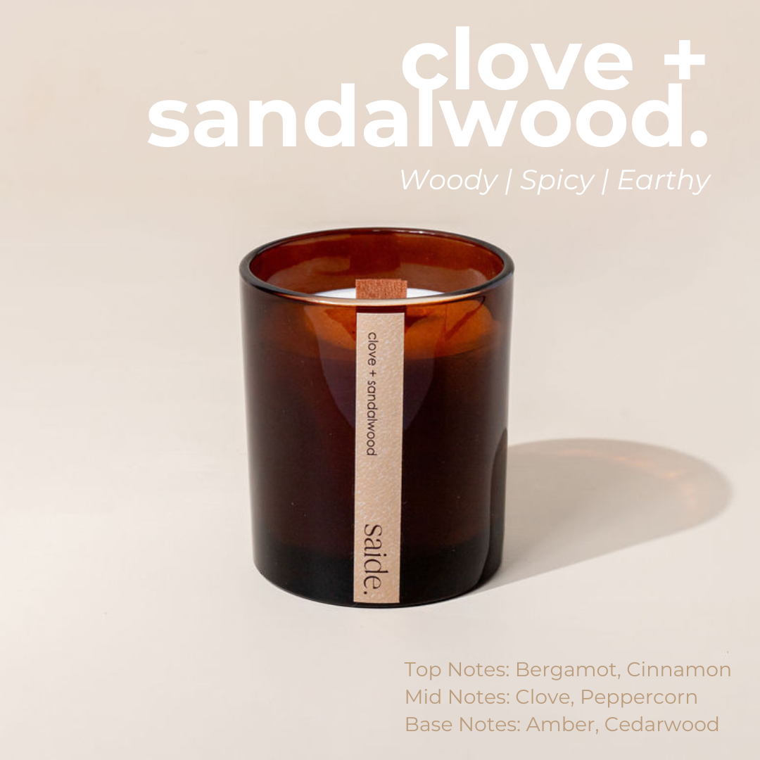 Candle with a label on a beige background, featuring the brand 'sade'.