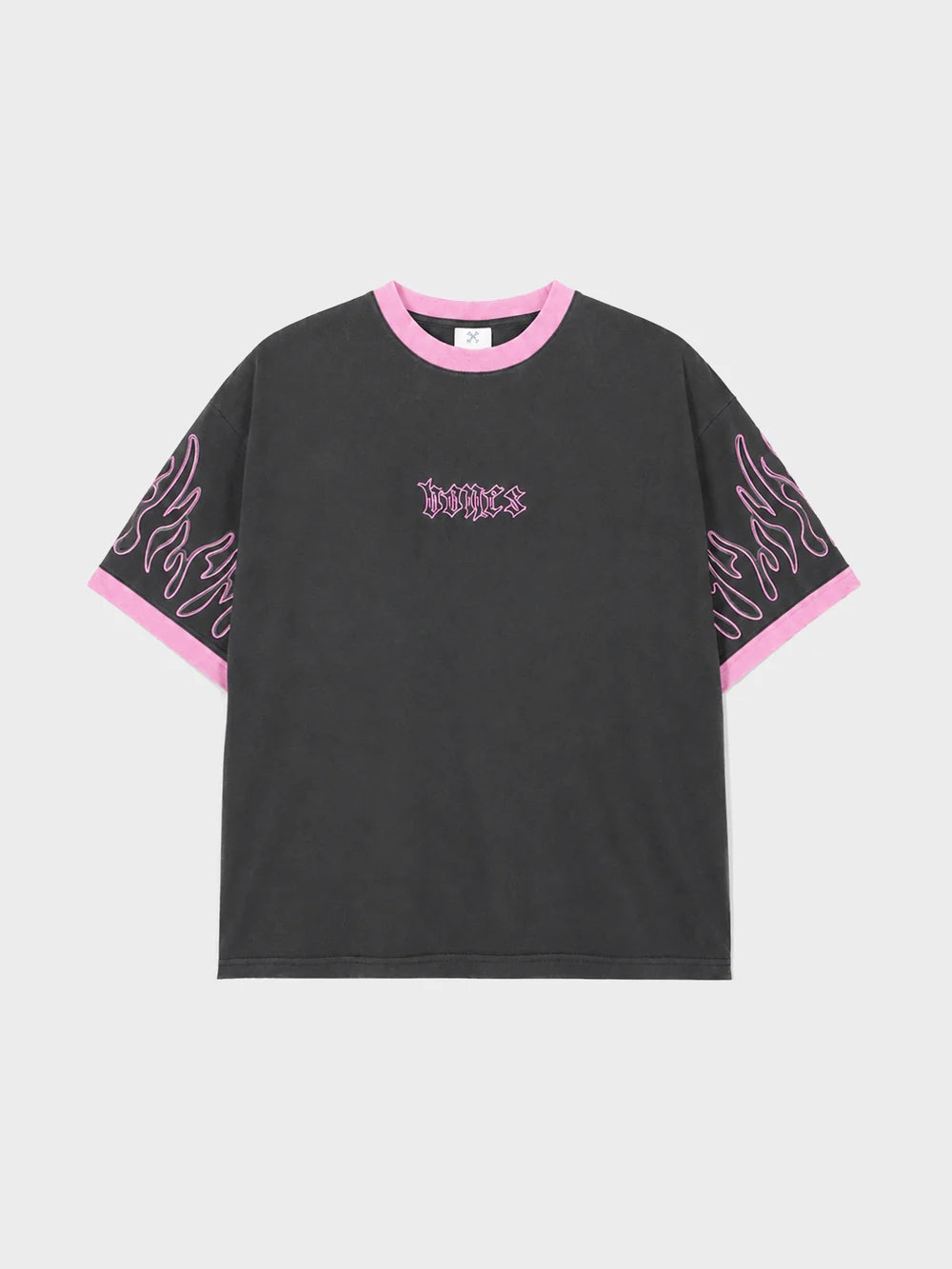 A black short-sleeve t-shirt with pink trim on the crew neck and sleeve cuffs, featuring pink flame-like graphic prints on the sleeves and a gothic-style 'justice' logo on the chest, displayed on a light gray background.
