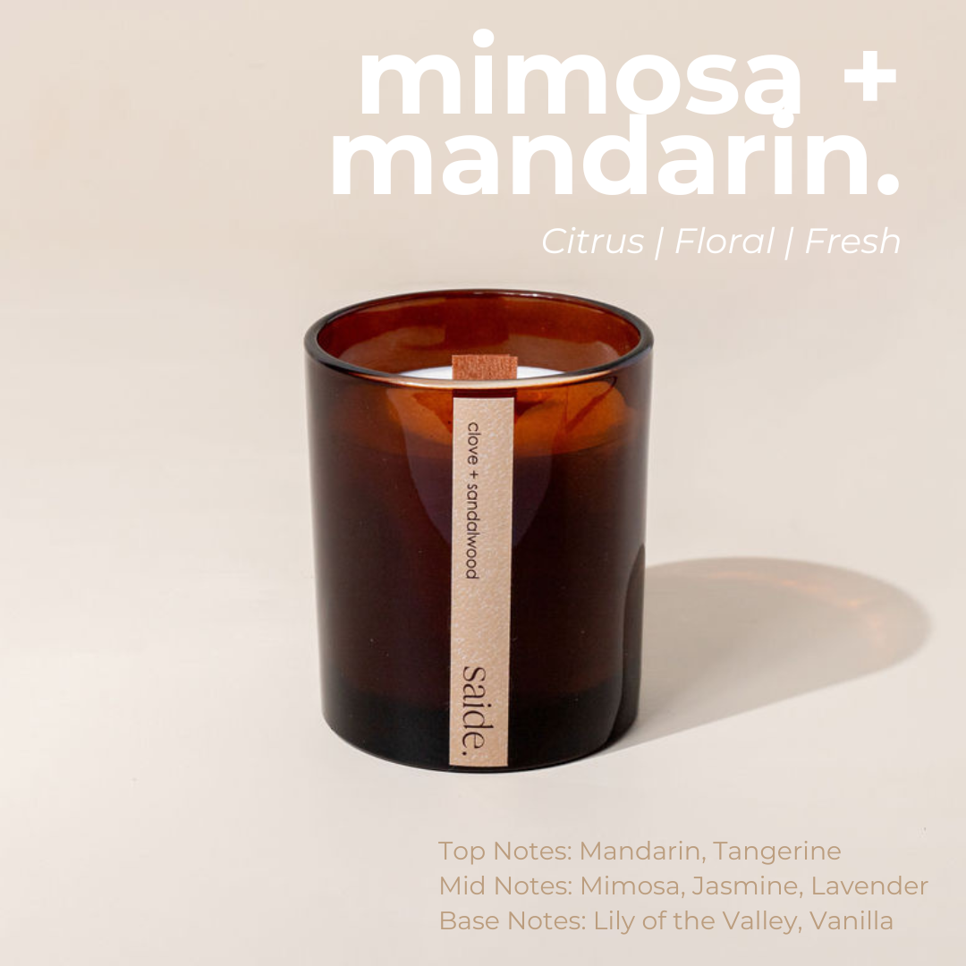 Brown candle labeled 'saide' with 'mimosa + mandarin' description on a beige background