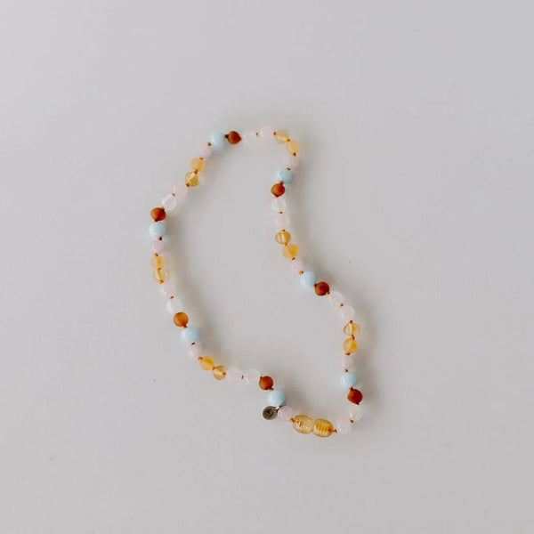 Necklace with multicolored beads on a light gray background