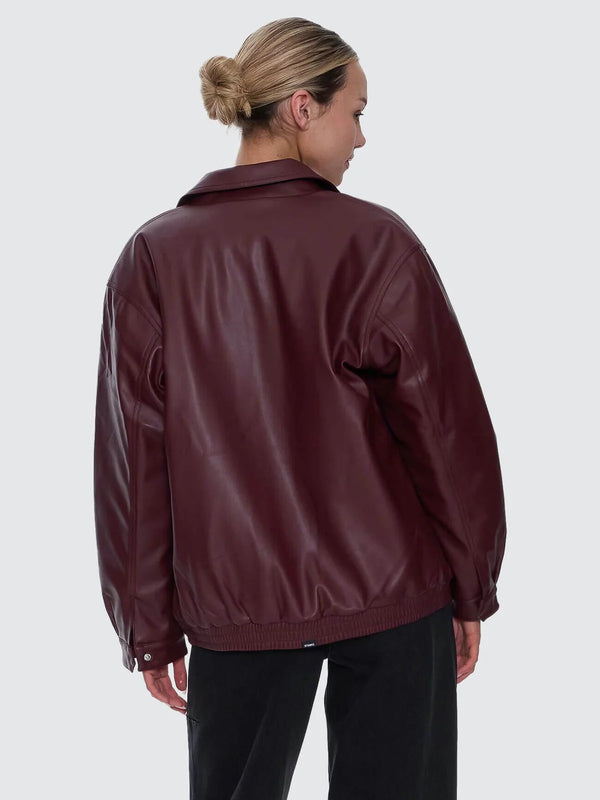 Person wearing a maroon leather jacket on a white background